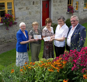 Image showing Mary Jordan of the Forge Restaurant and Dan Morley of Flogas presenting over €6,000 to local community organisations